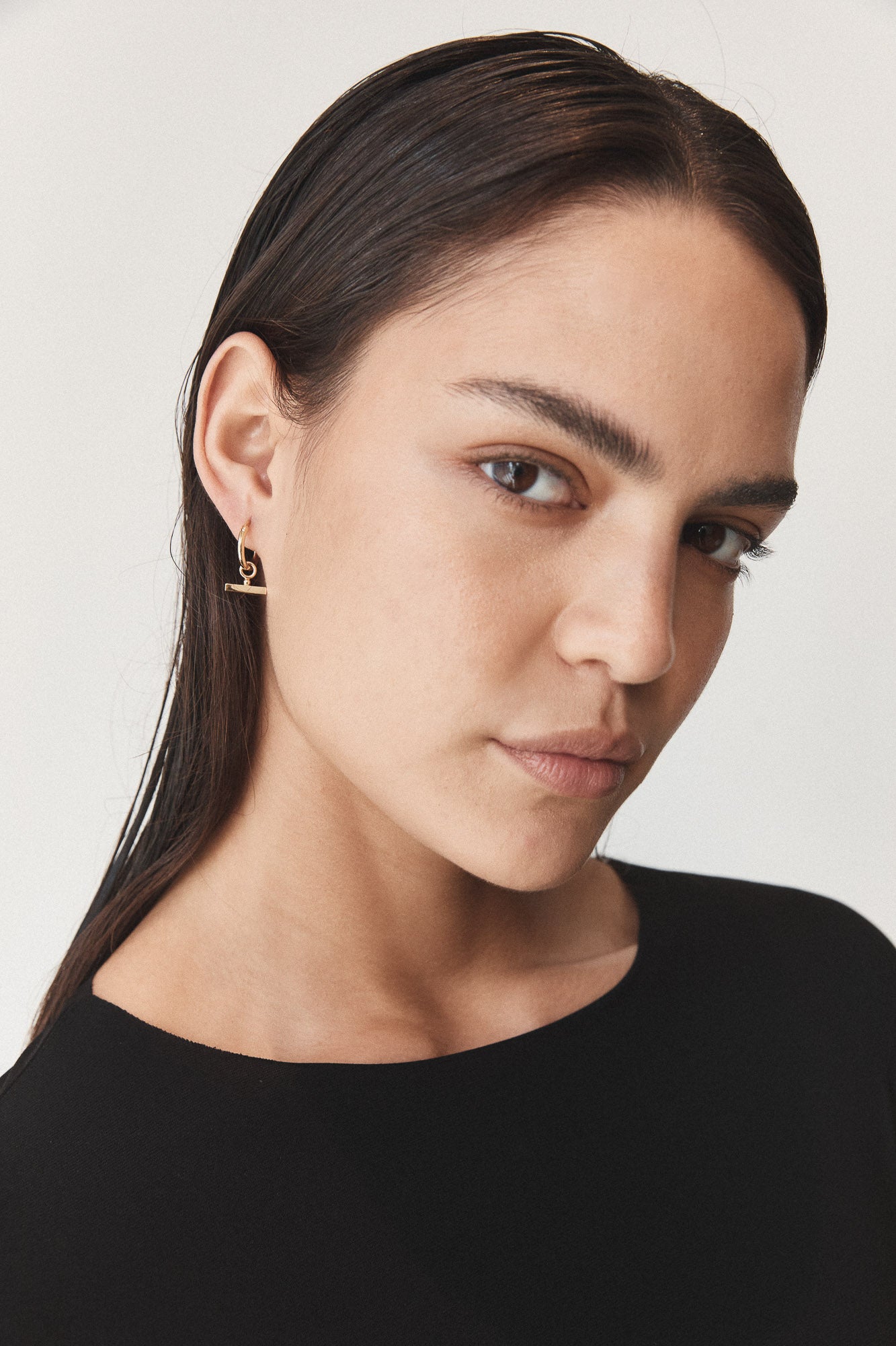 Flash Jewellery Chloe Sleeper Hoop Earrings in 14k Gold Vermeil on model